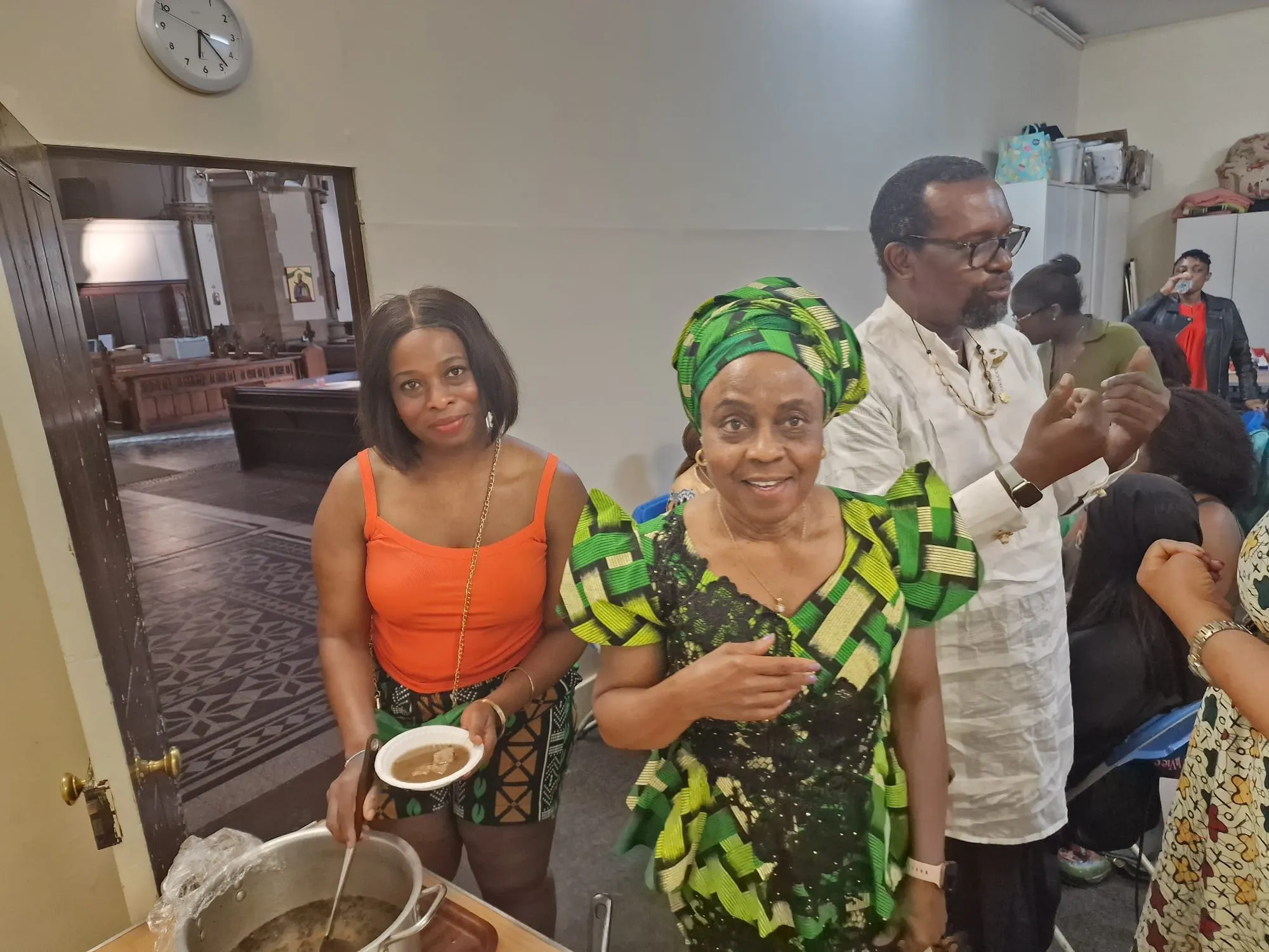 Members serving soup to one another in the church hall